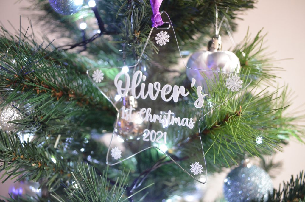 Engraved acrylic star decoration on a Christmas tree