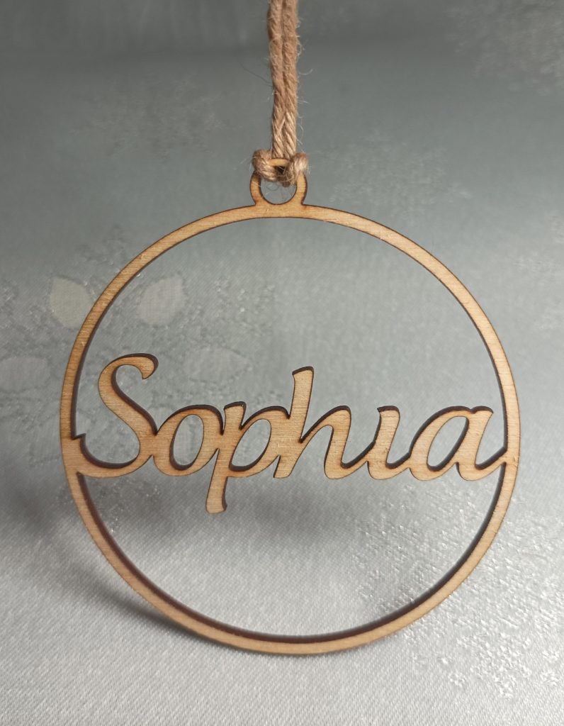 Laser-cut wooden name bauble reading Sophia